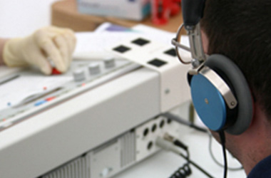 Person completing an audiometry exam with headphones on